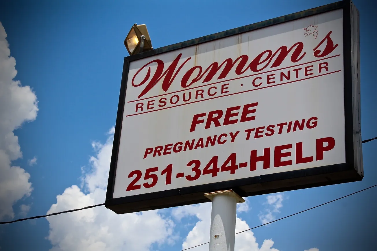a sign for an anti-abortion crisis pregnancy center adversiting free pregnancy testing.